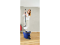 A woman using a spin mop and bucket set on a wooden floor