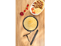 Crepes with strawberries, banana and chocolate, with jam and kitchen utensils.