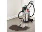 Wet and dry vacuum cleaner with dirt on a grey floor