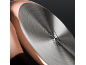 Close-up of the bottom of a copper-colored pan with a brushed metal base and cooking symbols