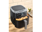 Black air fryer with a digital display showing '200' and a basket full of potato wedges.