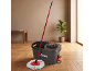 Red mop and grey bucket on the floor, with a houseplant in the background.