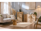 Bright living room with a grey sofa, round coffee table, and light wood sideboards.