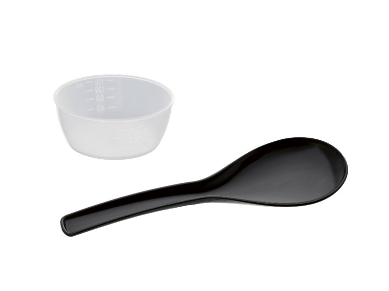 Translucent measuring cup and black serving spoon on a black background.
