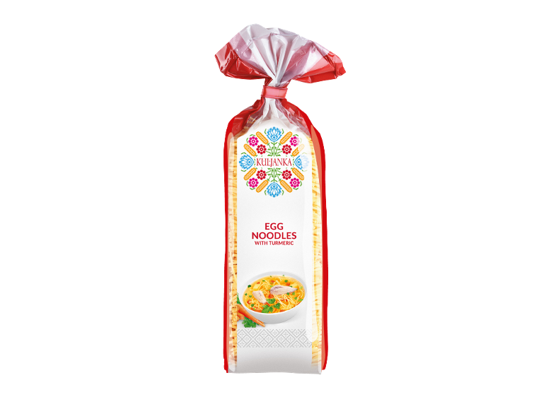 Packaging of egg noodles with a folk pattern and a bowl of noodle soup.