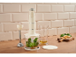 Cream immersion blender with chopper attachment, basil, and cheese on a wooden board.
