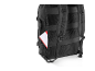 Black backpack with a red and white notebook in the side pocket.