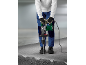 Gloved worker using a demolition hammer to break concrete.