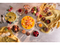 Table laden with desserts: cakes, macarons, fruits, and creams.