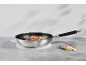Frying pan with chicken and cauliflower on a concrete table