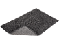 Grey bath mat with a non-slip backing, partially folded to show the texture.