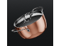 Copper cooking pot with a shiny lid and handles on a dark background.