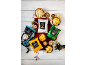Assortment of hand-cooked crisps and popcorn, with nuts and berries on a white wooden table.