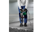 Gloved worker using a demolition hammer to break concrete.