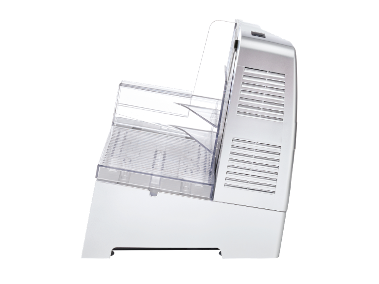 Side view of a white and clear plastic ice maker with vents on the side.