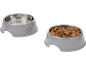 Two grey pet bowls, one empty and one filled with dry pet food.