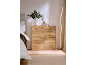 Wooden chest of drawers with doors, decorated with a vase, candles, and a floor lamp.