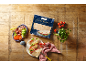 Flatbread with meat, tomato, and lettuce filling, with a package of flatbread.