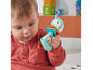 A baby in a red shirt playing with a fox-shaped rattle toy.