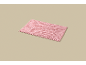 Pink bath mat on a beige background.