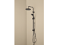 Black shower system with a rainfall and handheld showerhead in a bathroom corner.