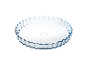 Round glass tart dish with a fluted edge.