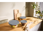 Kitchen counter with three glass food storage containers and wooden cutting boards.