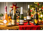 Five bottles of sparkling wine, including rosé, champagne, cava, and prosecco, on a festive table.
