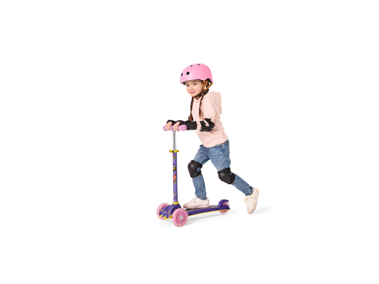 Girl with a pink helmet and protectors, standing on a purple and pink scooter.