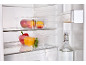Fridge with clear containers filled with fruits and vegetables, and a water bottle.