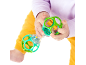 Baby playing with a green and transparent rattle