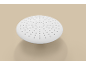 White round shower head with small nozzles on a beige background.
