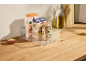 Kitchen organizer with organic products: couscous, pasta, and lentils, with olive oil.