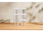 Clear stackable storage containers with white lids on a wooden table.