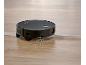 Black robot vacuum cleaner with Ultra Reach Brush on a wooden floor.