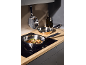 Frying pans with food on an induction hob in a modern kitchen.