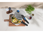 Pressure cooker with rice and vegetables, accompanied by spices and fresh herbs.