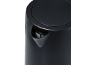 Close-up of a black electric kettle with a spout and lid.
