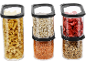 Transparent containers with pasta, oats, dried strawberries, lentils, and granola.