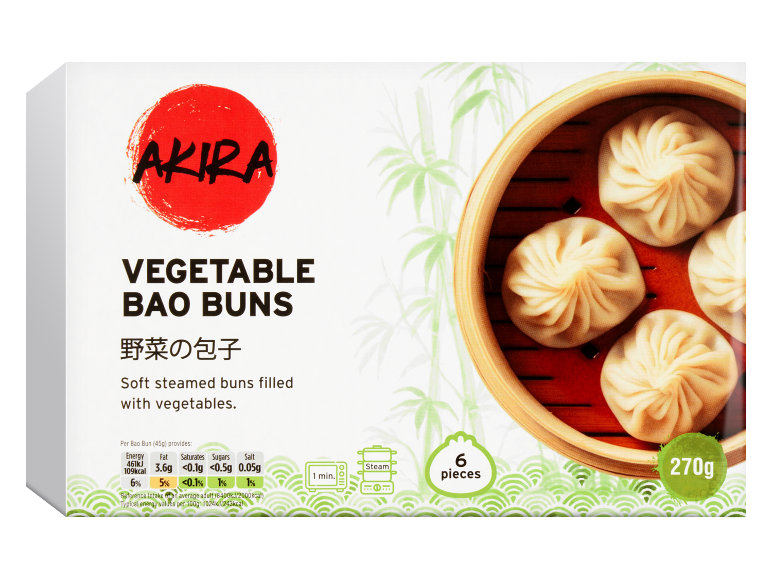 Box of vegetable bao buns with a steamer basket of buns on the right.