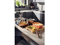 Copper cookware, frying pan with salmon and rice in a modern kitchen.