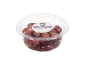 Greek Kalamata olives with pits in a transparent plastic container.
