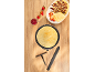 Crepes with strawberries, banana and chocolate, with jam and kitchen utensils.