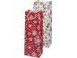 Christmas gift bags: one red with snowflakes, one white with nutcrackers and fir trees.