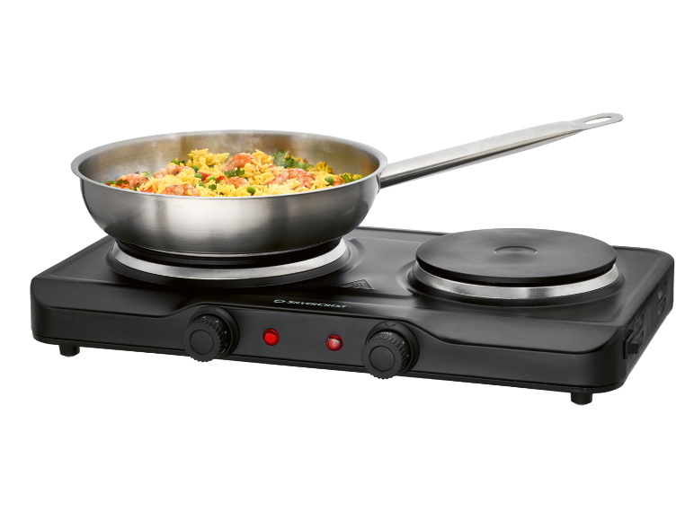 Portable double hot plate with a pan of food.