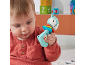A baby in a red shirt playing with a fox-shaped rattle toy.
