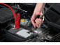 Jump-starting a car with jumper cables, a man connecting a clamp.