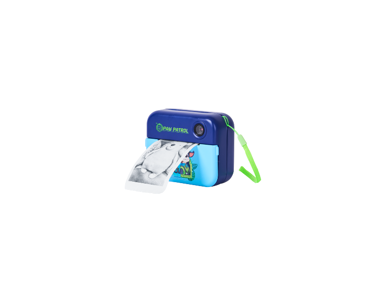 Blue instant print camera with a Paw Patrol design, printing a black and white image.