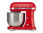 Red stand mixer with a stainless steel bowl and the number 1973 on top.