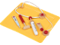 Wooden toy doctor kit with stethoscope, syringe, thermometer, and ointment.
